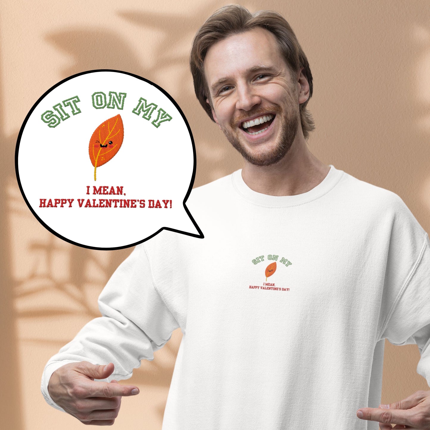Add a spark of humor to Valentine’s Day with our ‘Sit On My (smiling leaf design)’ sweatshirt!