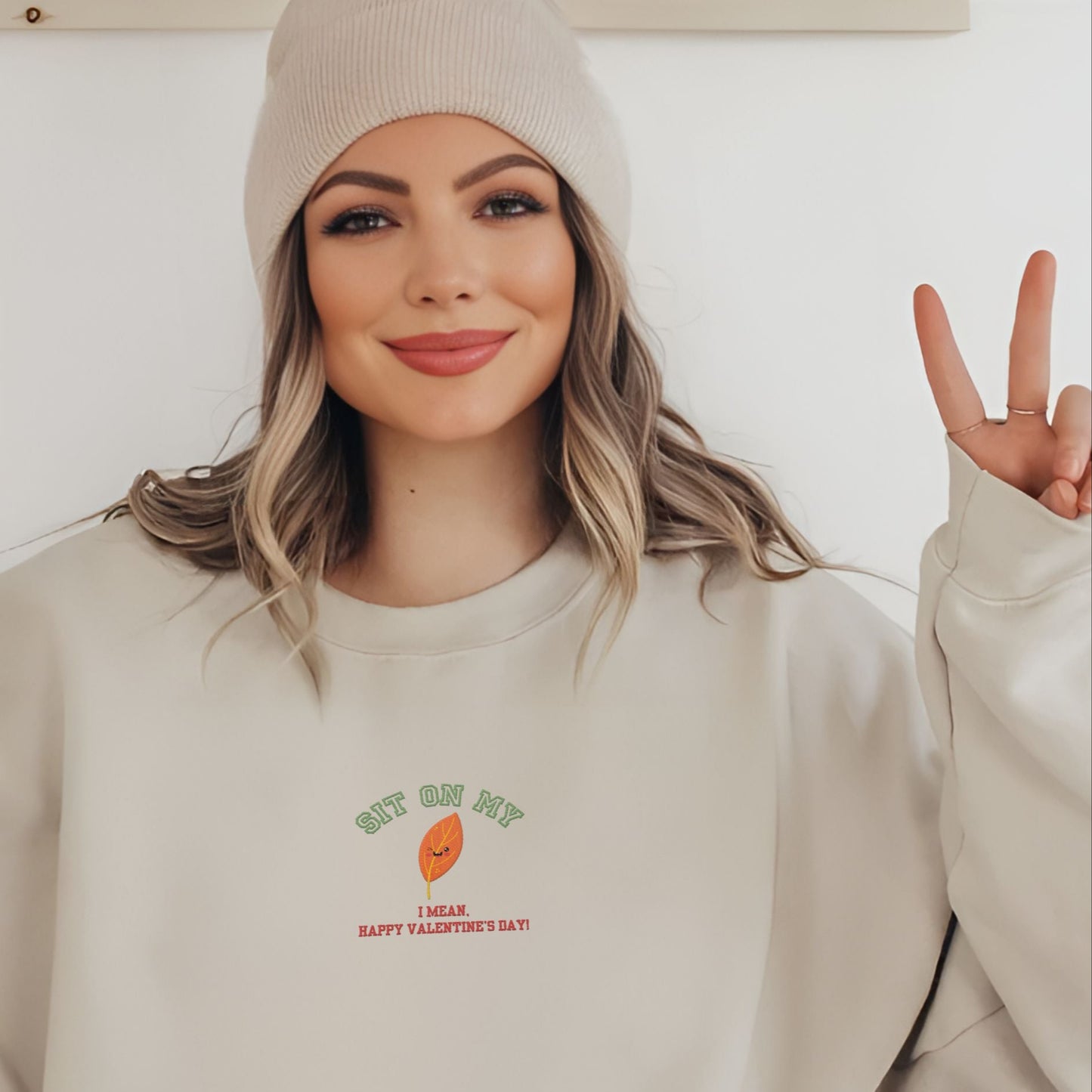 Add a spark of humor to Valentine’s Day with our ‘Sit On My (smiling leaf design)’ sweatshirt!