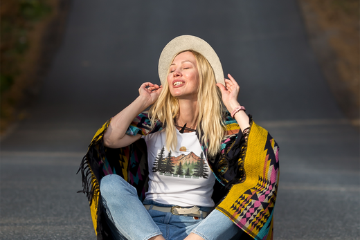 "Smiling woman with closed eyes sitting in the middle of a peaceful road, radiating calm, happiness, and a deep connection to the present moment."