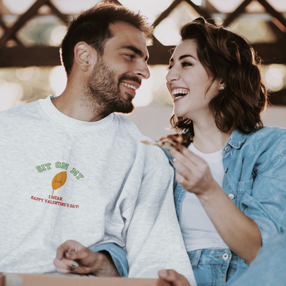 Add a spark of humor to Valentine’s Day with our ‘Sit On My (smiling leaf design)’ sweatshirt! 
